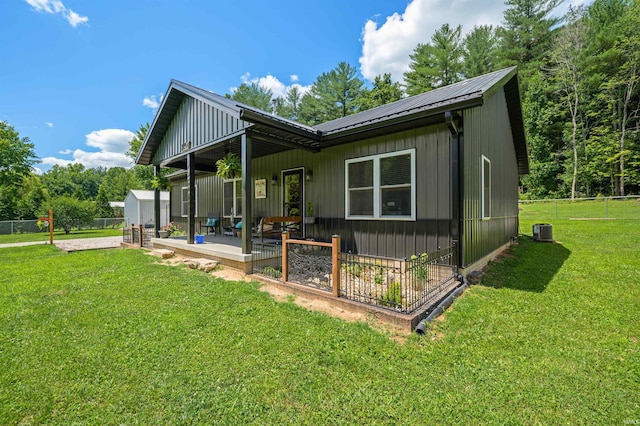 rear view of house featuring a patio, a lawn, and cooling unit