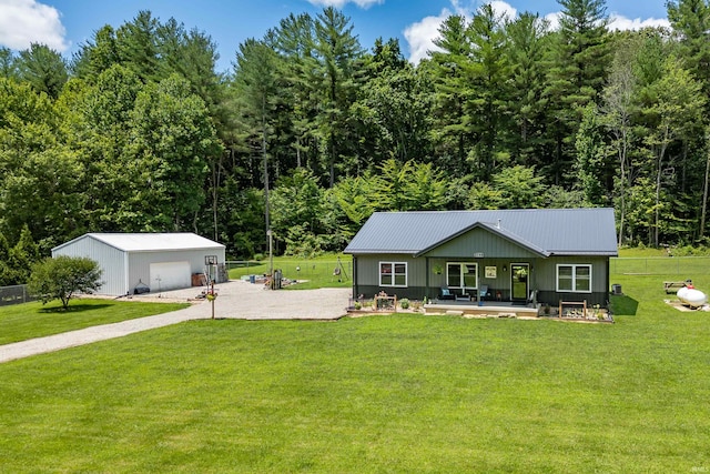 single story home with a garage, covered porch, an outdoor structure, and a front lawn