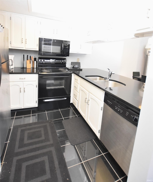 kitchen with dark tile patterned floors, sink, white cabinets, and black appliances