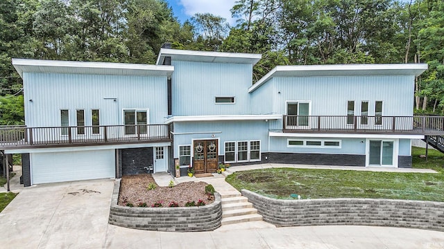 back of property with a garage and french doors