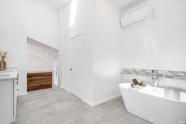 bathroom featuring a tub, vanity, tile patterned flooring, and high vaulted ceiling