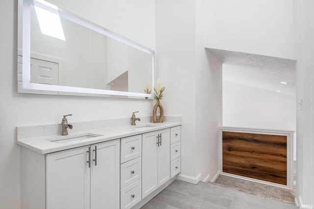 bathroom with dual vanity and tile patterned flooring