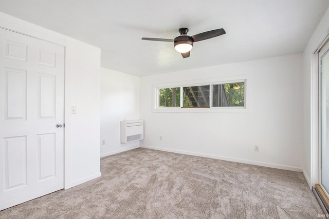 unfurnished bedroom with light colored carpet, heating unit, and ceiling fan