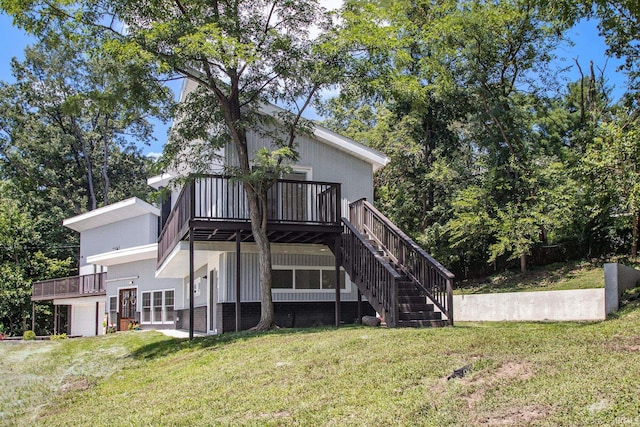 back of house featuring a deck, a patio, and a yard