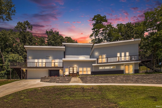 contemporary house with a garage, a yard, and french doors