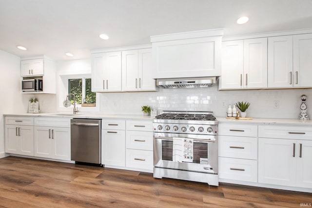 kitchen featuring appliances with stainless steel finishes, white cabinetry, and dark hardwood / wood-style floors