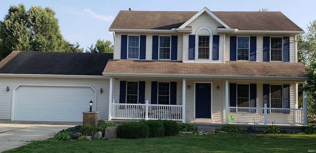 view of front of house featuring a garage, covered porch, and a front lawn