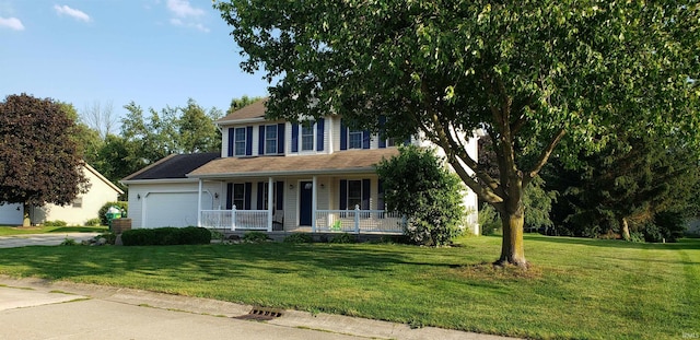 view of front of house with a porch, a garage, and a front lawn