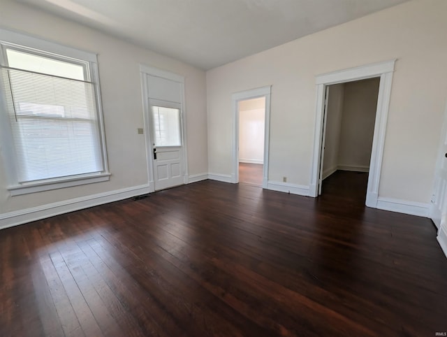 empty room with baseboards and hardwood / wood-style floors