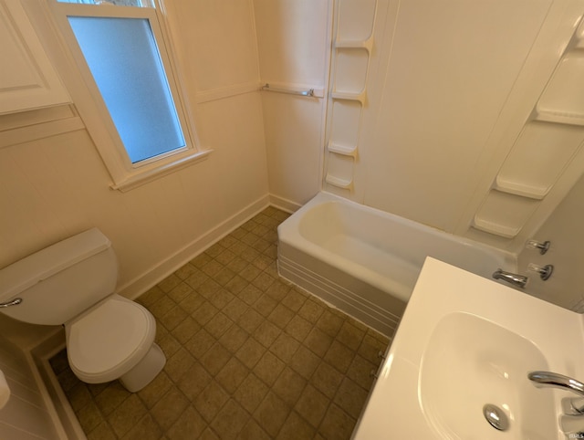 full bathroom with a sink, toilet, bathtub / shower combination, and baseboards