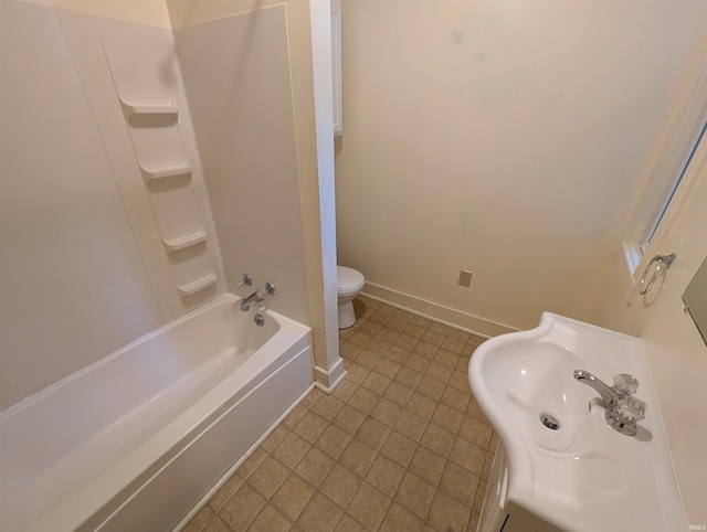 full bathroom with baseboards, a sink, toilet, tile patterned flooring, and bathing tub / shower combination