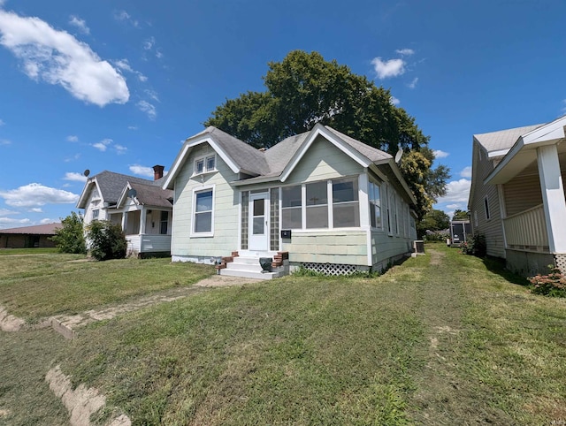 bungalow-style house featuring a front yard