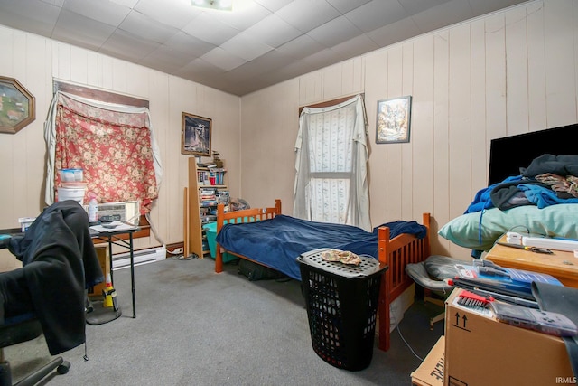 bedroom featuring carpet flooring, baseboard heating, and a paneled ceiling