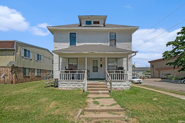 view of front of home with a garage, central air condition unit, a front lawn, and covered porch