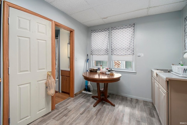 bathroom with hardwood / wood-style flooring, a drop ceiling, and vanity