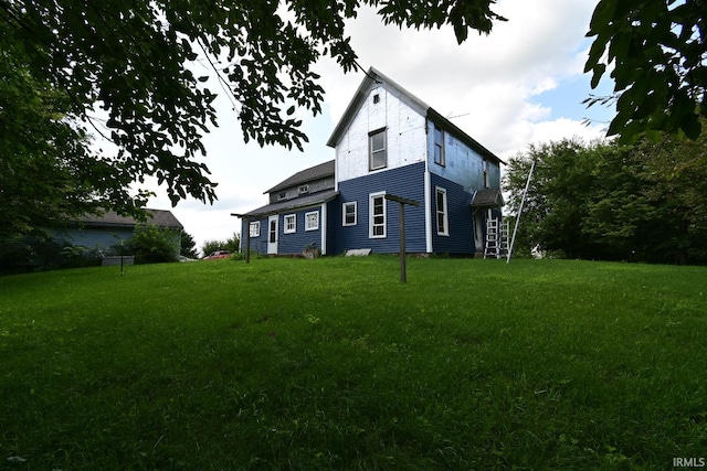 back of house featuring a lawn