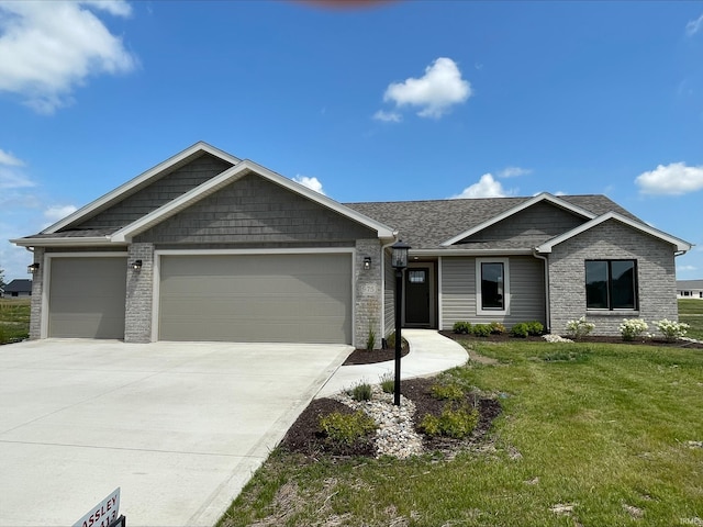 view of front facade featuring a front yard, an attached garage, brick siding, and concrete driveway