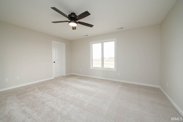 unfurnished room featuring light carpet and ceiling fan