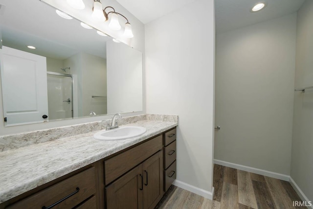 bathroom featuring vanity, hardwood / wood-style floors, and an enclosed shower