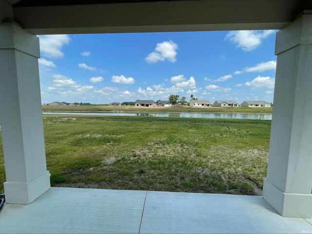 view of yard with a patio and a water view