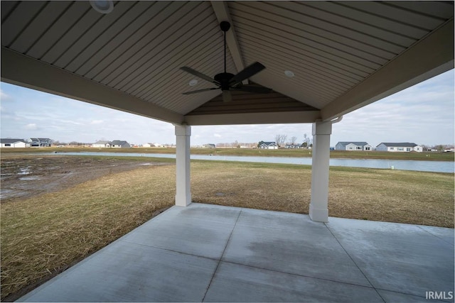 view of patio / terrace with a water view and ceiling fan