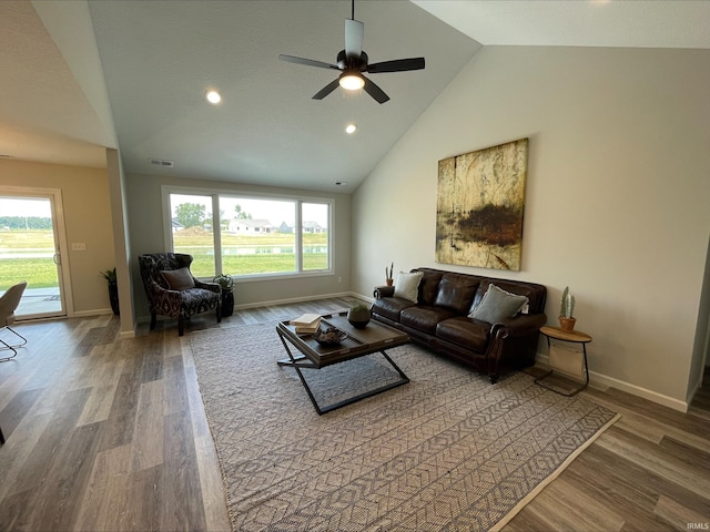 living room featuring ceiling fan, a healthy amount of sunlight, hardwood / wood-style floors, and high vaulted ceiling