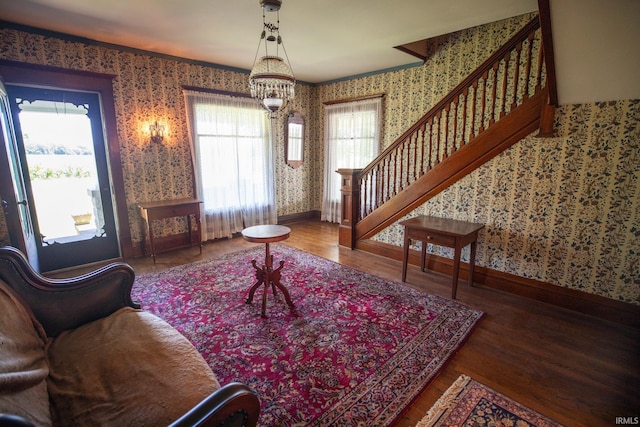 living room with an inviting chandelier and hardwood / wood-style floors