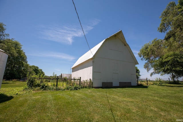 view of property exterior with a lawn and an outdoor structure