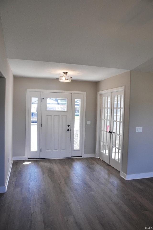 entrance foyer with plenty of natural light, dark hardwood / wood-style flooring, and french doors