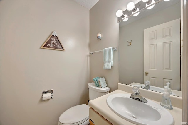 bathroom featuring toilet and vanity