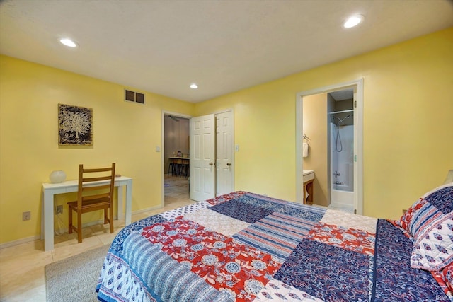 bedroom featuring light tile patterned flooring and connected bathroom