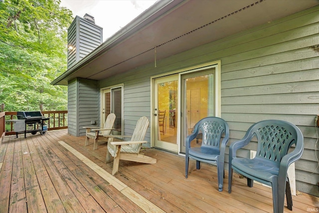 wooden deck featuring a grill