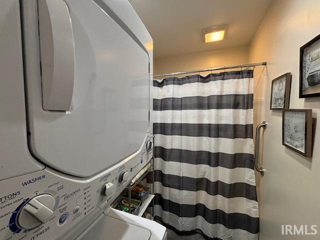 bathroom featuring stacked washing maching and dryer