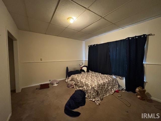 carpeted bedroom with a drop ceiling