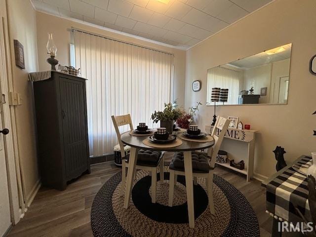 dining space featuring dark hardwood / wood-style flooring and crown molding