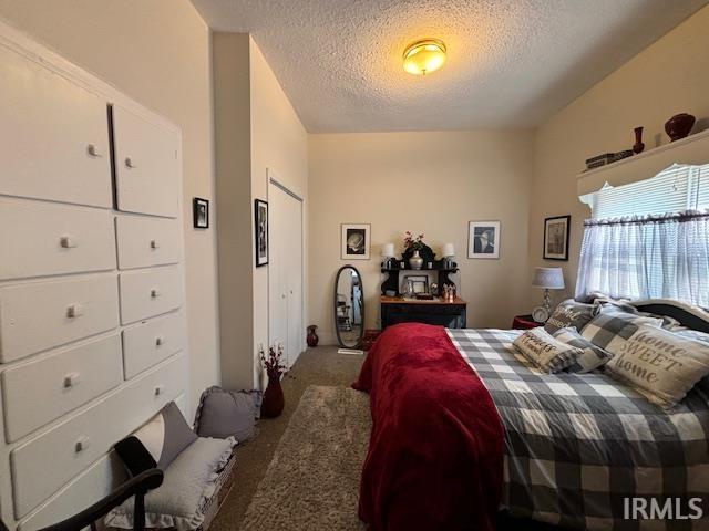 carpeted bedroom with a textured ceiling