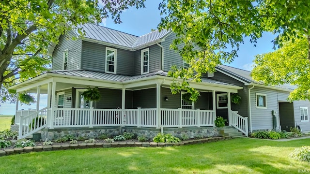 view of front of property featuring covered porch and a front lawn