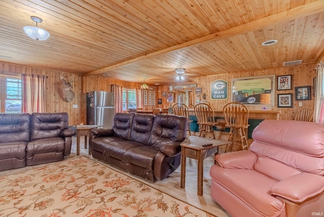 living room featuring wood ceiling, wooden walls, and beamed ceiling