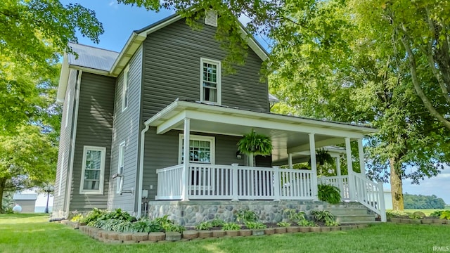 view of front of property with a porch and a front lawn