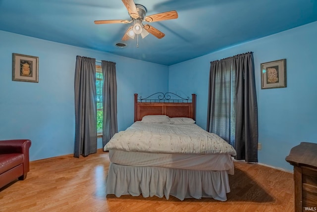 bedroom featuring ceiling fan and light hardwood / wood-style flooring