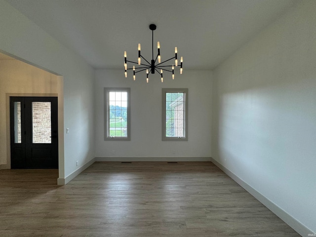 interior space featuring a notable chandelier and hardwood / wood-style flooring