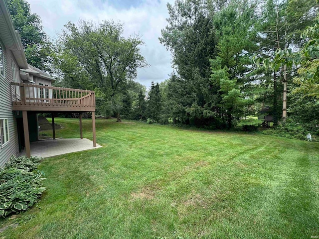 view of yard with a patio area and a wooden deck