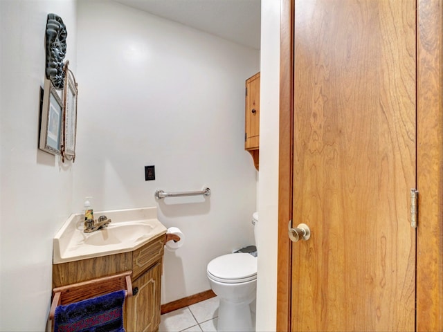 bathroom featuring tile patterned flooring, toilet, and vanity