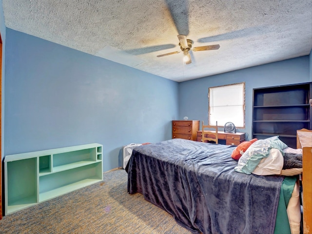 carpeted bedroom featuring a textured ceiling and ceiling fan