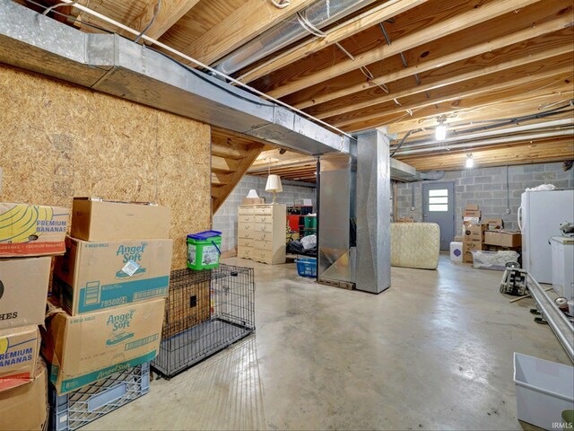 basement featuring white fridge