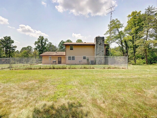 back of property with a lawn