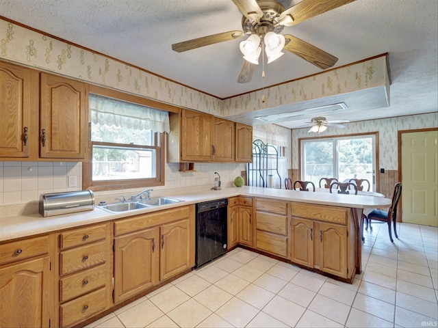 kitchen featuring black dishwasher, sink, kitchen peninsula, crown molding, and a textured ceiling