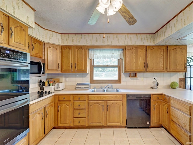 kitchen with sink, light tile patterned floors, ceiling fan, stainless steel appliances, and a textured ceiling