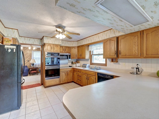 kitchen featuring black appliances, sink, backsplash, light tile patterned flooring, and ceiling fan