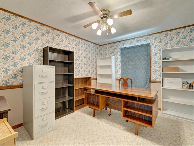 home office featuring light carpet, a textured ceiling, crown molding, and ceiling fan